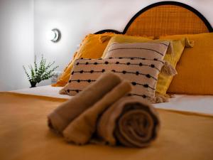 a bed with a bunch of pillows on it at Canaima Sea View/Terrace/Pool in Mogán