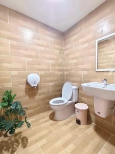 a bathroom with a toilet and a sink at SNOW HOUSE Buriram in Buriram