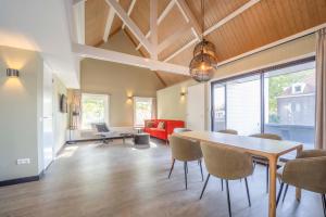 a dining room and living room with a table and chairs at Fletcher Hotel-Restaurant Waalwijk in Waalwijk