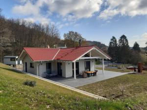 Landhaus Zeitlos في هايمباخ: بيت ابيض صغير بسقف احمر