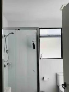 a bathroom with a shower and a glass door at 2Bedrooms 2Bathrooms Oasis in Parramatta w parking in Sydney