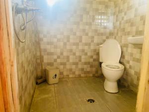 a small bathroom with a toilet in a room at Kivu Macheo eco-lodge in Kibuye