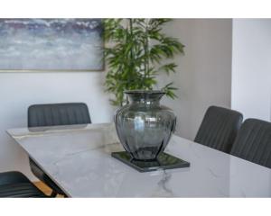 a glass vase sitting on top of a table at Central Belfast Apartments Pottinger's Quay in Belfast