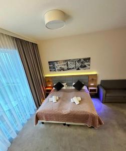 a bedroom with a large bed and a couch at RentResidence apartament in Sienna