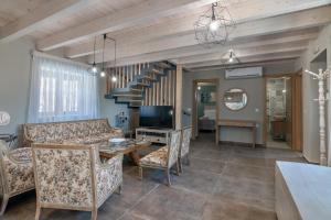 a living room with a couch and a table at Alexandras's Mansion - Alexinia's House in Ayiá