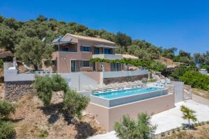 an aerial view of a house with a swimming pool at Alexandras's Mansion - Fragkia's House in Ayiá