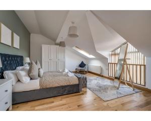 a bedroom with a large bed and a staircase at Central Belfast Apartments Pottinger's Quay in Belfast
