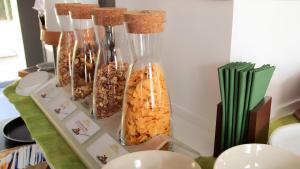 a group of vases filled with different types of food at Apartment Hotel Lindeneck in Erfurt