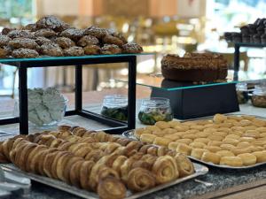 a buffet with different types of pastries and cakes at Hotel Thàlas Club in Torre dell'Orso