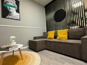 a living room with a couch and a table at Svatého Pasáž BOUTIQUE Apartments with free parking in Trnava