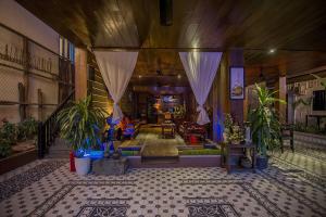 a living room with potted plants on a tiled floor at RESIDENCE 1960 in Siem Reap
