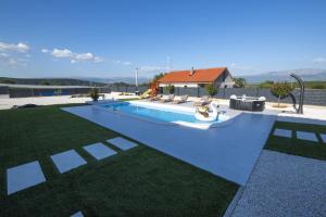a swimming pool in a yard with a house at Villa Noemi in Sinj
