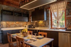 a kitchen with a table with chairs and a counter top at Villa Iris in Milatos
