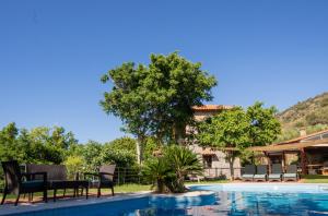 a resort with a swimming pool and a house at Villa Iris in Milatos