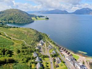 an aerial view of a village on the shore of a lake at Holly Tree Hotel, Swimming Pool & Hot Tub in Glencoe