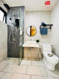 a bathroom with a shower and a toilet and a sink at The Shore Maison Life 小居屋 in Kota Kinabalu +101 photos