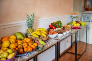 a table filled with lots of fruits and vegetables at Taormina Garden Hotel in Taormina