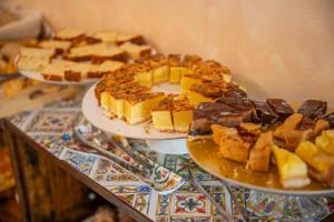 three plates of food on a table with desserts at Taormina Garden Hotel in Taormina