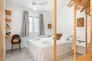 a bedroom with a white bed and a mirror at Marce in Ciutadella
