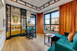 a living room with a couch and a table at DOKI Living & Foodhall by Downtown Apartments in Gdańsk +35 photos