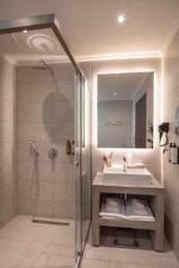 a bathroom with a sink and a shower at IRA - ΗΡΑ City Hotel in Kalamata