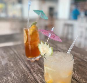 two cocktails on a wooden table with a drink at The Nautilus Pemba in Pemba