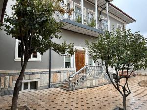 a house with a wooden door and a porch at VILLA ANOR in Yakkasaray
