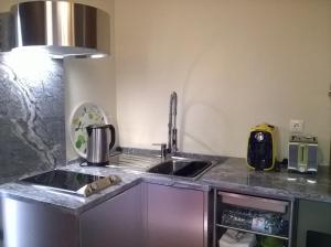 a kitchen with a sink and a counter top at Alma N' Sleep in Almancil