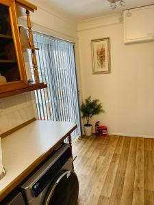 a kitchen with a wooden floor and a counter top at Peaceful 3 Bed Home in Basildon