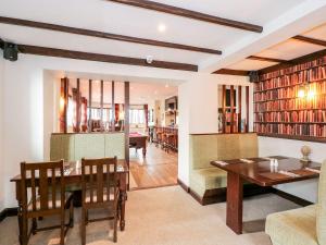 a dining room and living room with a table and chairs at The Five Bells Inn in Wisbech