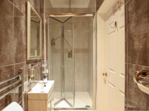 a bathroom with a shower and a sink at The Five Bells Inn in Wisbech +69 photos