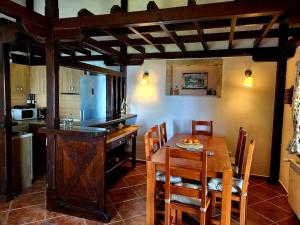 a kitchen and dining room with a wooden table and chairs at Villa Nera in Budva