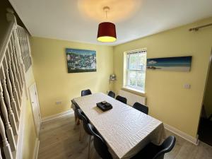 a dining room with a table and chairs at Greenwich Cottage - Part of the The Bay Filey Holiday Village with pool, gym and direct beach access, pub, restaurant, tennis and meadows walks in Reighton