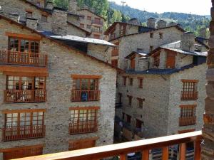 a group of buildings with windows and balconies on them at Ático acogedor centro de Canillo in Canillo