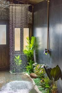 a bathroom with a shower with plants in it at The Ark Comforts in Palolem
