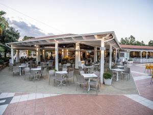 a restaurant with tables and chairs on a patio at Holiday Home 4 Mori- Deluxe - MUV105 by Interhome in Muravera