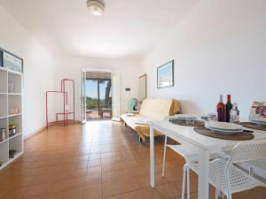 a living room with a white table and a couch at Apartment Elbamar Lacona I-3 by Interhome in Capoliveri