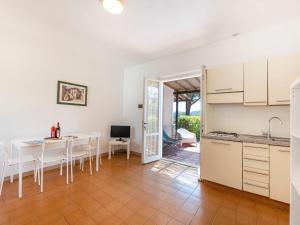 a kitchen and dining room with a table and chairs at Apartment Elbamar Lacona I-3 by Interhome in Capoliveri