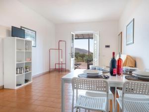 a dining room with a white table and chairs at Apartment Elbamar Lacona I-1 by Interhome in Capoliveri