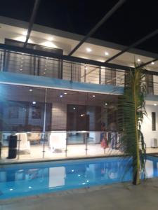 a building with a swimming pool at night at PREM VILLA in Petit Raffray