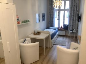 a room with a bed and a table and chairs at Gemütliche Koje in Rostock