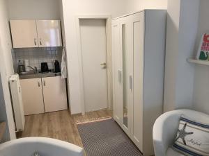 a small bathroom with a sink and a toilet at Gemütliche Koje in Rostock