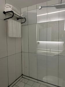 a bathroom with a glass shower with a sink at Kançul Hotel Taştepeler in Sanlıurfa