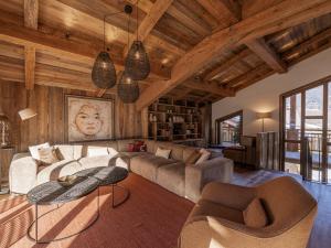 a living room with a couch and a table at Chalet Courchevel, 6 pièces, 10 personnes - FR-1-568-33 in Courchevel