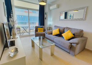 a living room with a couch and a glass table at Modern Renovated One Bed Apartment in Edificio Apolo Marbella Center in Marbella