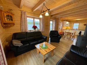 a living room with a couch and a table at Holiday Home Chalet Sven by Interhome in Spiegelau