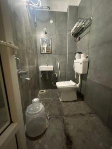 a bathroom with a toilet and a sink at Parambara - A Heritage Stay in Puducherry