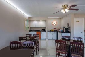 a dining room and kitchen with a table and chairs at Howard Johnson by Wyndham Vero Beach/I-95 in Vero Beach