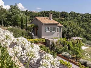 a house with a garden with white flowers at San Canzian Hotel & Residences in Buje