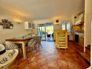 a kitchen with a table and chairs in a room at Marinabay 5 in Grimaud +20 photos